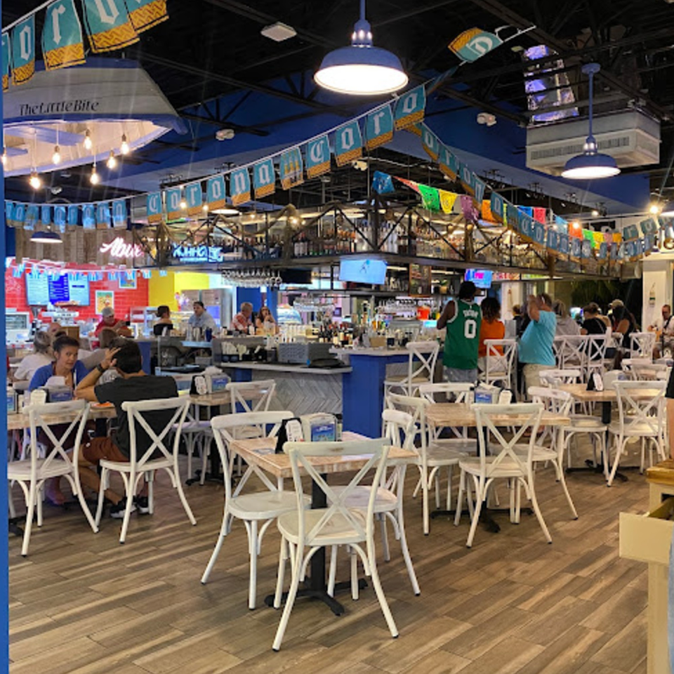 The Bite Eatery's interior with customers dining at tables and a bar area in the background.